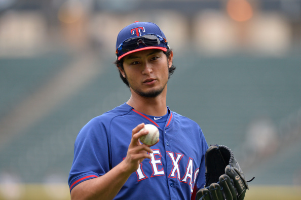 CHICAGO, IL - AUGUST 4: Yu Darvish #11 of the Texas Rangers stands on the field during batting practice before the game against the Chicago White Sox at U.S. Cellular Field on August 4, 2014 in Chicago, Illinois. The White Sox defeated the Ranger 5-3 in a rain-shortened game. (Photo by Brian D. Kersey/Getty Images)